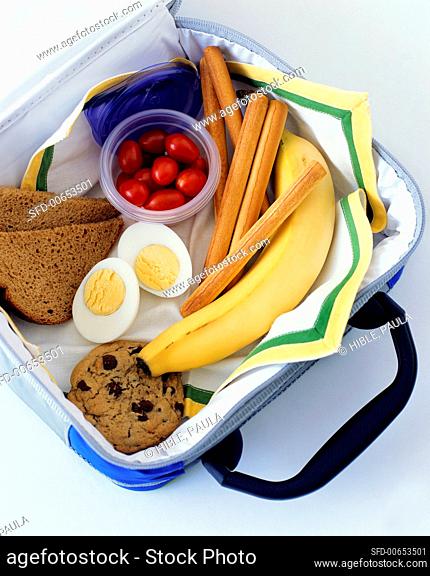 Lunch box with banana, cookie, egg, bread etc