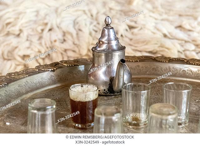 Teapot rests on silver tray with glasses for traditional Moroccan tea ceremony, Tighmert Oasis, Morocco
