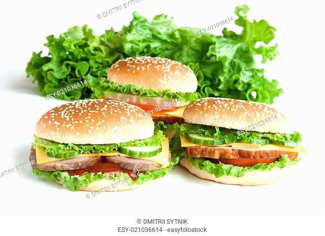 three burger with meat and vegetables