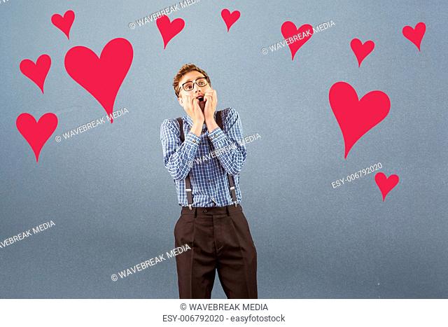 Composite image of geeky hipster biting his nails
