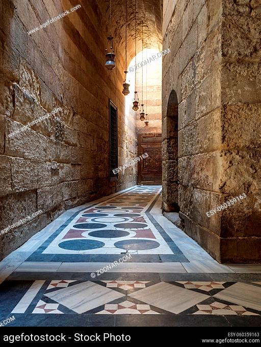 Vaulted passage leading to the Courtyard of Sultan Qalawun mosque with geometrical pattern colorful marble floor, Moez Street, Old Cairo, Egypt