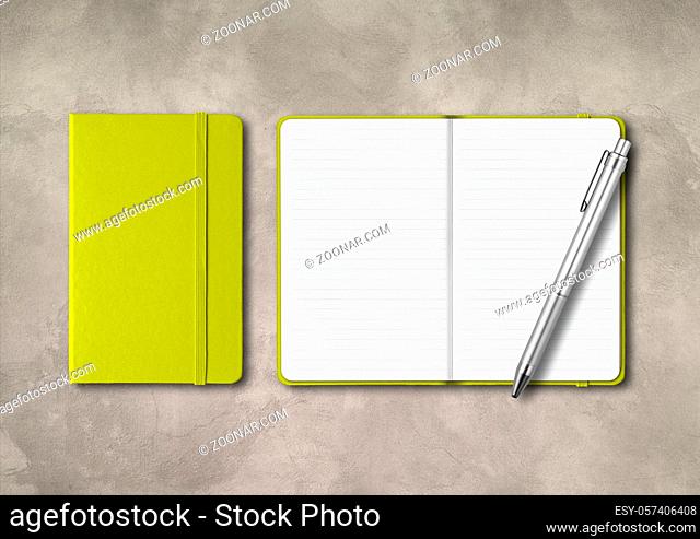 Lime green closed and open lined notebooks with a pen . Mockup isolated on concrete background