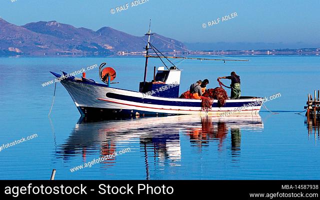 Italy, Sicily, west coast, Marsala, fisherman, fishing boat, fish market, fishing boat, fishermen, glassy sea, reflection in water, mountains