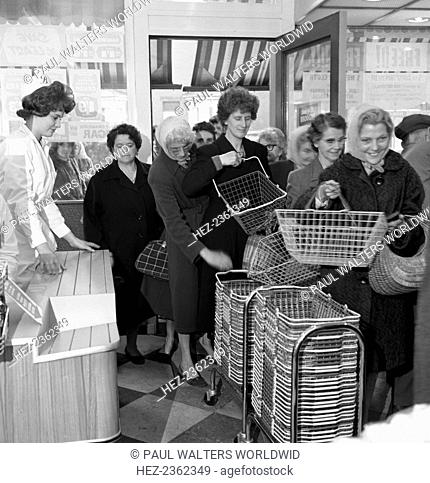 Opening of Brough's supermarket, Thurnscoe, South Yorkshire, 1963. Eager shoppers collect their baskets as the doors open on the newly refurbished Brough's Ltd...