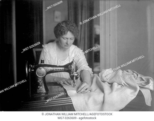 USA -- circa 1920 -- A woman uses one of the first SINGER sewing machines. Image courtesy US Library of Congress -- Picture by Lightroom Photos / US LoC