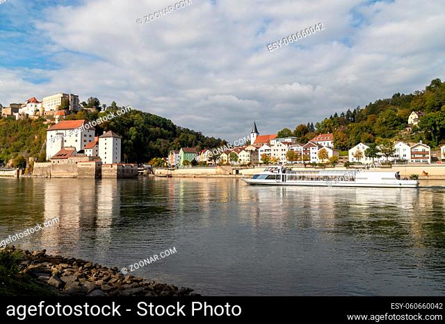 View at Fortress Veste Oberhaus, Danube shore and entry of river Ilz in Passau, Bavaria, Germany in autumn with Danube river and passenger ship