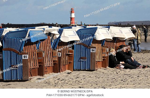 After the heavy autumn storm 'Herwart' beach visitors enjoy the sun at the Baltic Sea beach in Warnemuende, Germany, 30 October 2017