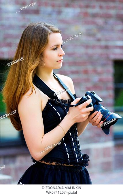 Young woman with a photo camera