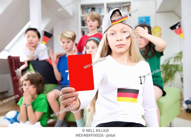Girl showing red card in front of friends, watching football world cup