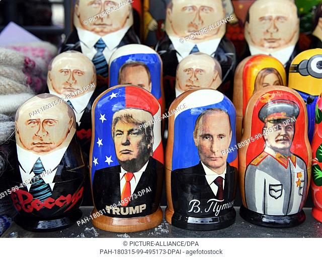 15 March 2018, Russia, St. Petersburg: Matryoshka dolls with the portraits of (left to right) Russian President Vladimir Putin