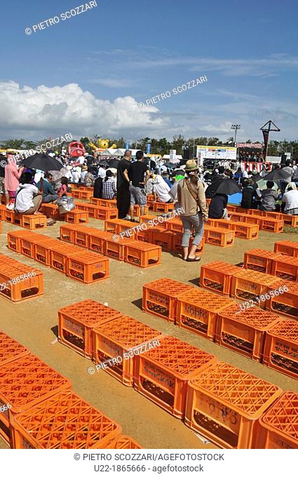 Uruma City, Okinawa, Japan, Orion beer boxes used as chairs at Eisa Festival