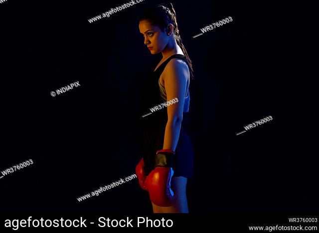 PORTRAIT OF A WOMAN BOXER STANDING ALONE
