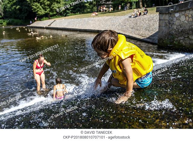 A boy enjoys water on the Viktorie's Weir in the Upa River in the Grandmother's Valley, in Ratoborice, on August 1, 2018. (CTK Photo/David Tanecek)