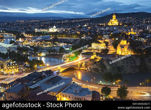 Tbilisi, Georgia. Evening Night View Of Georgian Capital Skyline. Scenic Top View Of Summer Evening Cityscape Of Tbilisi