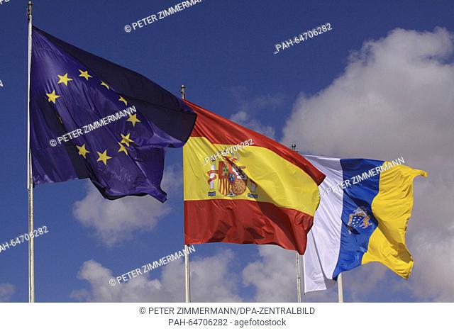Spains national flag on the Arrecife Airport on the Canary Island Lanzarote, Spain, 10 October 2015. Next to it is the flag of the Canary Islands (R) and the...