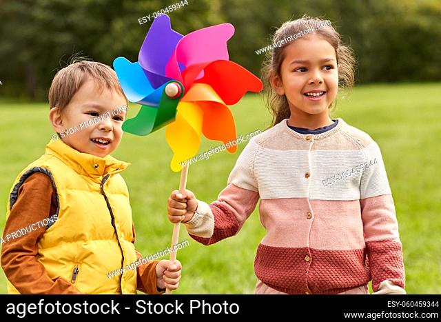 happy kids with pinwheel having fun at park
