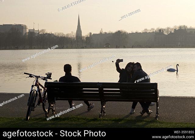 Couple taking a selfie photo at Hyde Park in London, England, UK