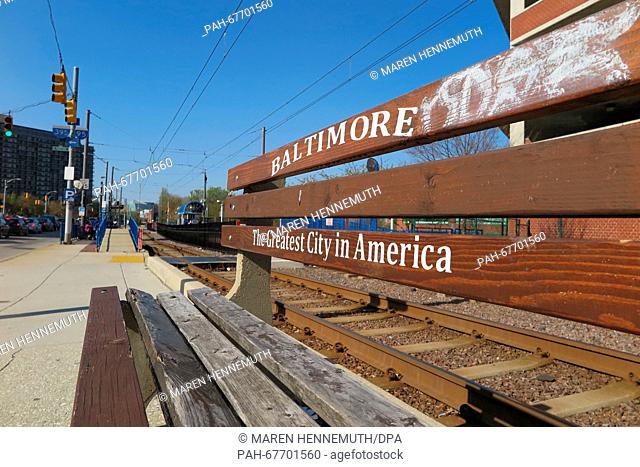The writing on a deserted bench reads 'Baltimore - The Greatest City in America' at a train stop in Baltimore, USA, 14 May 2016