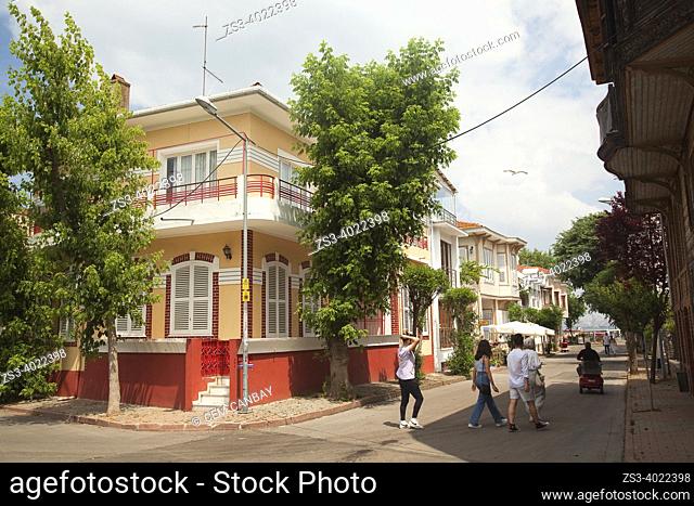 Tourists walking in front of the traditional wooden houses with balconies in Büyükada, Buyukada-Prinkipos, the largest of the Princes' Islands, Marmara Sea