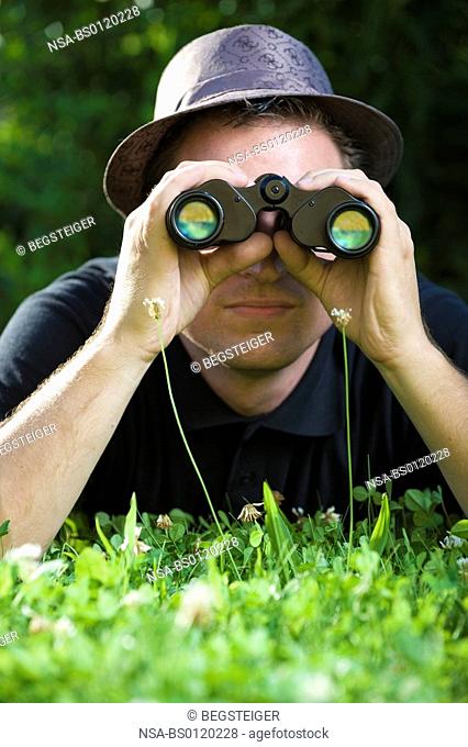 man with spy glass in meadow