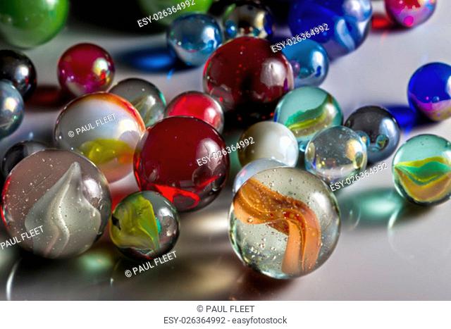 Closeup view of translucent marbles on a shiny surface