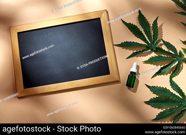 hemp essential oil, chalkboard and cannabis leaves