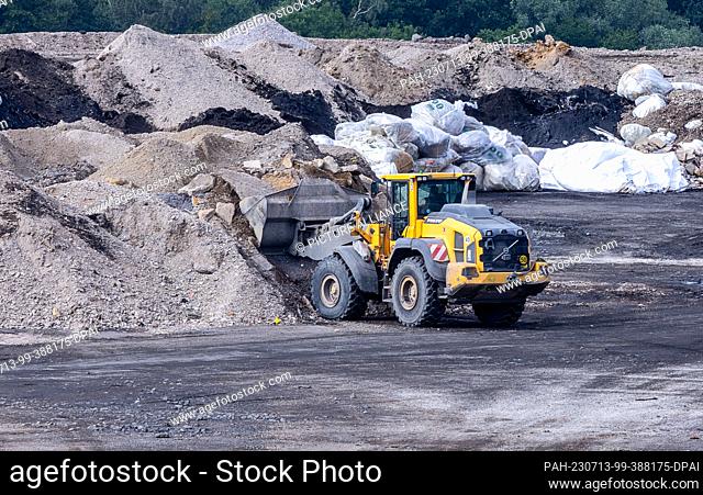 13 July 2023, Mecklenburg-Western Pomerania, Schönberg: A wheel loader transports material in an area of the Ihlenberg landfill