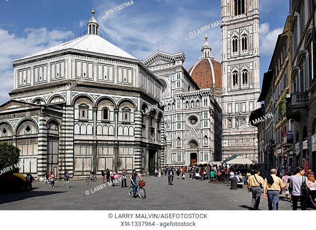 Tourists along the Piazza del Duomo with the Basilica di Santa Maria del Fiore in Florence, Italy