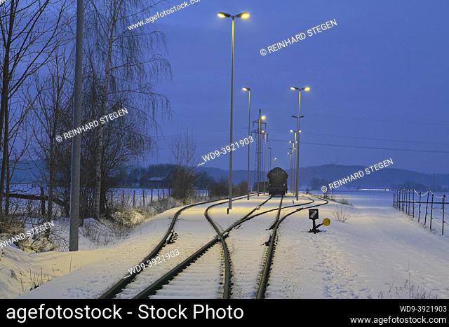 stabling sidings, rails, railway in winter with snow, cold night, waggon