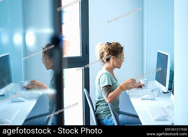Modern adult woman work at home or office desktop computer - young adult freelance people with online free job and internet connection - pretty caucasian lady...
