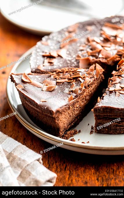 Sweet chocolate cheese cake on wooden table