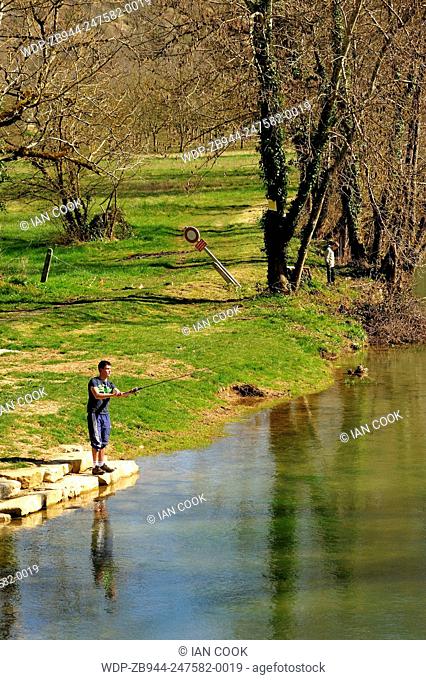 man fishing in Le Ceou River at Saint-Cybranet, Dordogne Department, Aquitaine, France