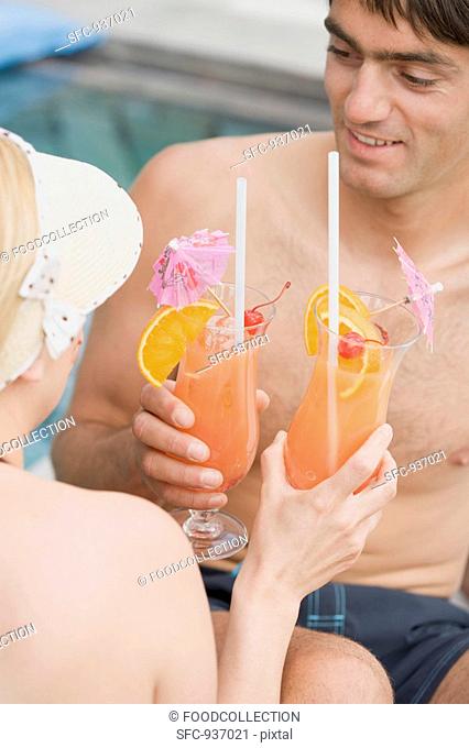 Man and woman with Planter's Punch by pool