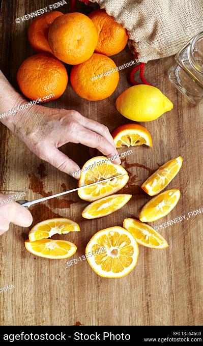 Man cutting oranges for marmalade, Southend-on-sea, Essex, England, UK