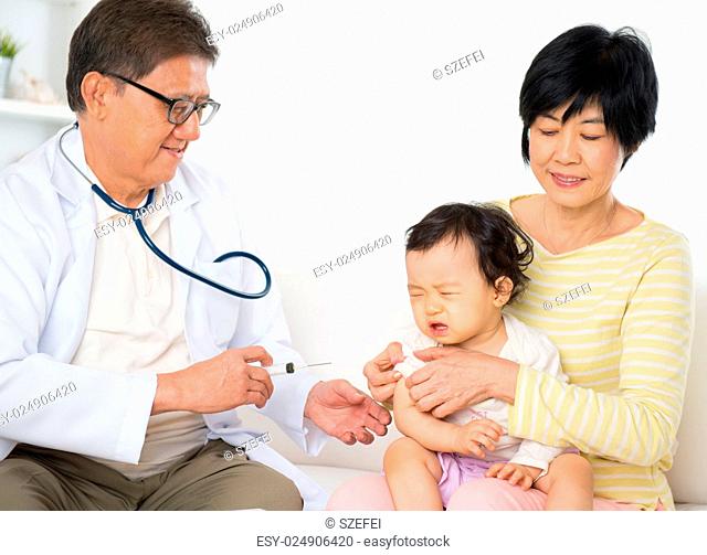 Family doctor vaccines or injection to baby girl. Pediatrician and patient