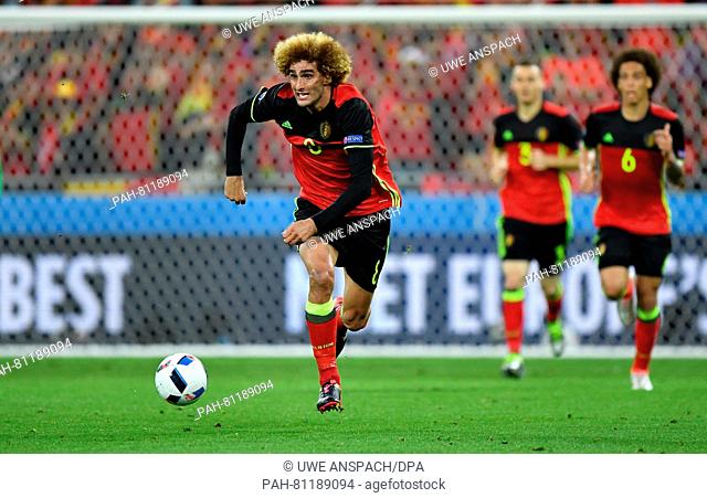Marouane Fellaini (L) of Belgium goes for the ball during the Group E soccer match of the UEFA EURO 2016 between Belgium and Italy at the Stade de Lyon in Lyon