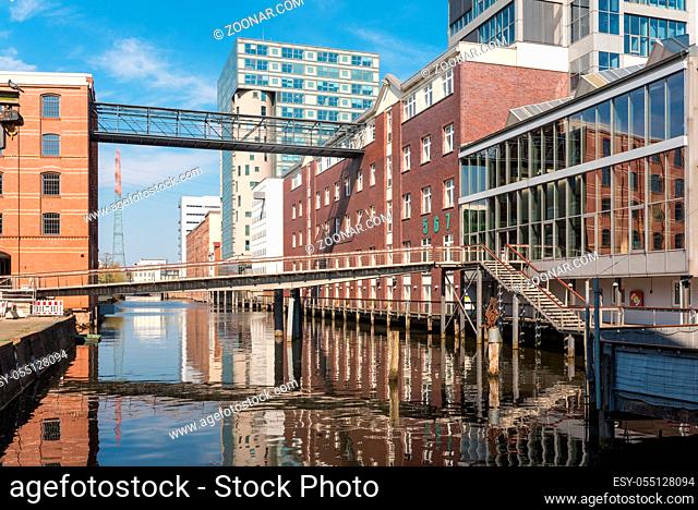 Urban development in the Harburg inland port. Old converted warehouses and new office buildings in the harbour. The city and the district are part of the...