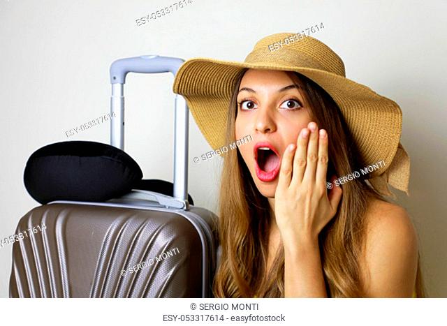 Portrait of surprised girl with hat before traveling