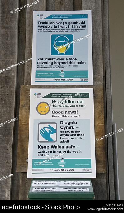 Bilingual Welsh-English sign warnings due to Coronavirus, Covid-19 pandemic near the beach in Ynyslas at the Dyfi estuary, near Borth and Aberystwyth