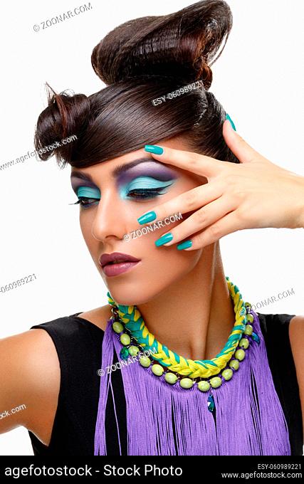 Beautiful young woman with bright purple make-up and fancy hairdo. Long green nails. Beauty shot isolated on white background. Copy space
