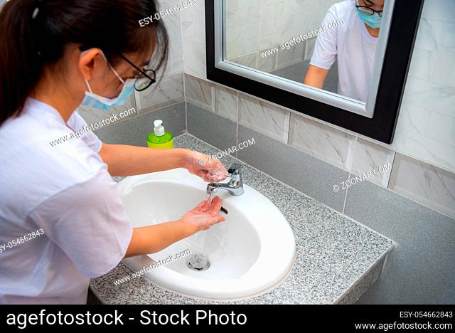 Woman wash hand cleaning with soap in the sink, Disinfection to stop the coronavirus or prevent the spread of the Covid 19 outbreak