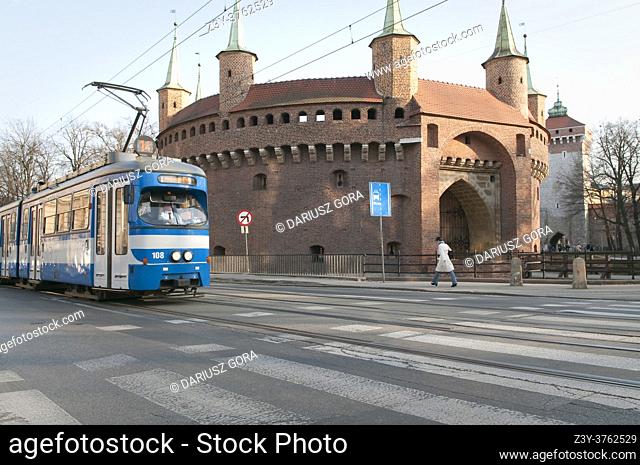 Tram passing Barbakan in Krakow, Poland