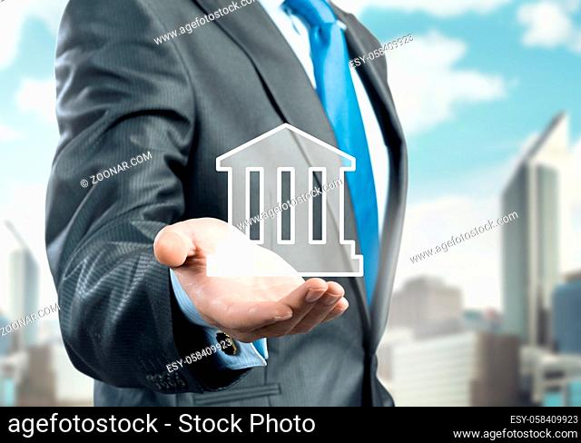 Hand of businessman showing house sign in palm