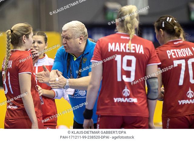 Russia head coach Yevgeni Trefilov giving directions to his players during a time-out during the 2017 World Women's Handball Championship eighth-finals match...