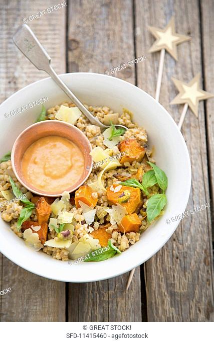 Barley salad with pumpkin, Greyerzer cheese, pistachios and a dried tomato sauce