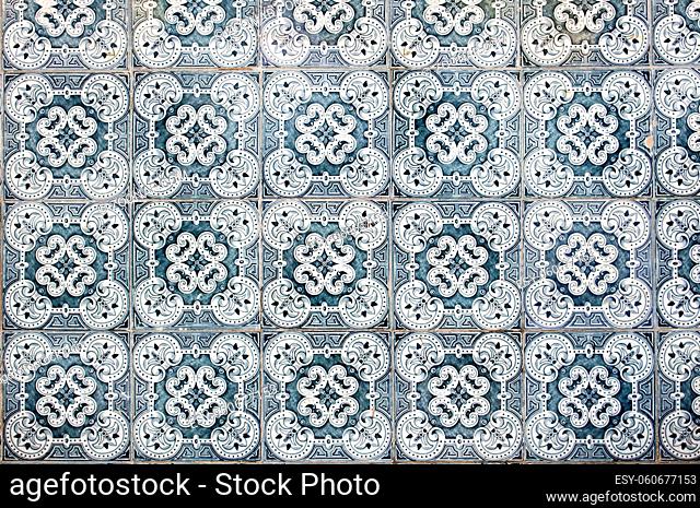 Horizontal photo of traditional Portuguese ceramic blue tiles with abstract pattern. Vintage glazed tiles texture and background