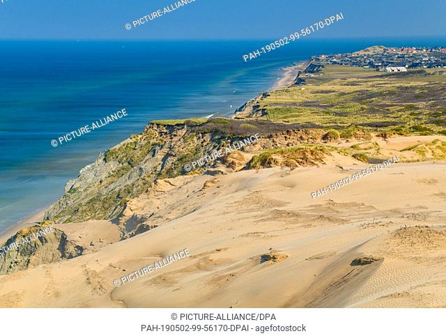 23 April 2019, Denmark, Lönstrup: Panoramic view from the lighthouse Rubjerg Knude at the North Sea steep coast in the municipality Rubjerg (municipality...