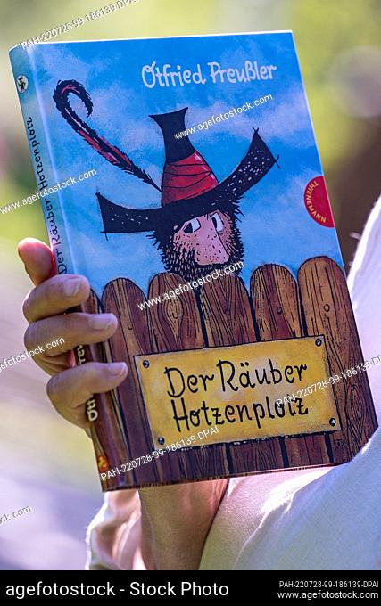 28 July 2022, Bavaria, Regen: The book ""The robber Hotzenplotz"". A pointed hat with a feather, a bushy full beard and curious eyes: this is how children know...