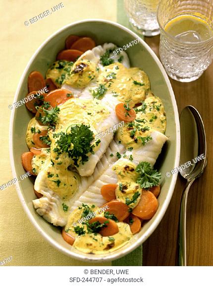 Baked coley on carrots with mustard