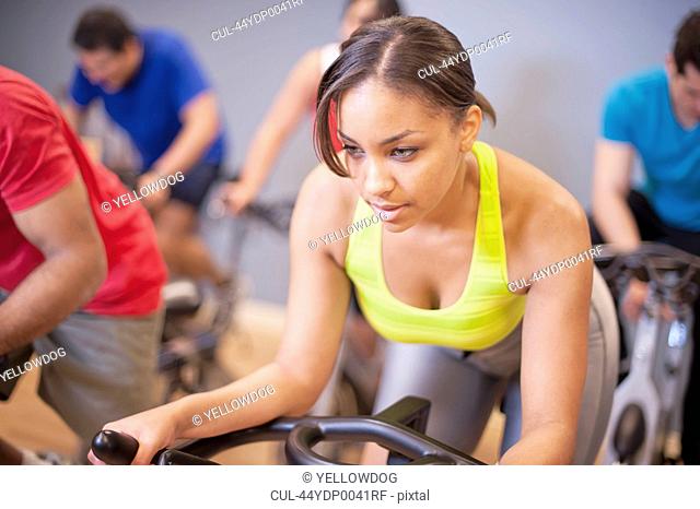 People using spin machines in gym